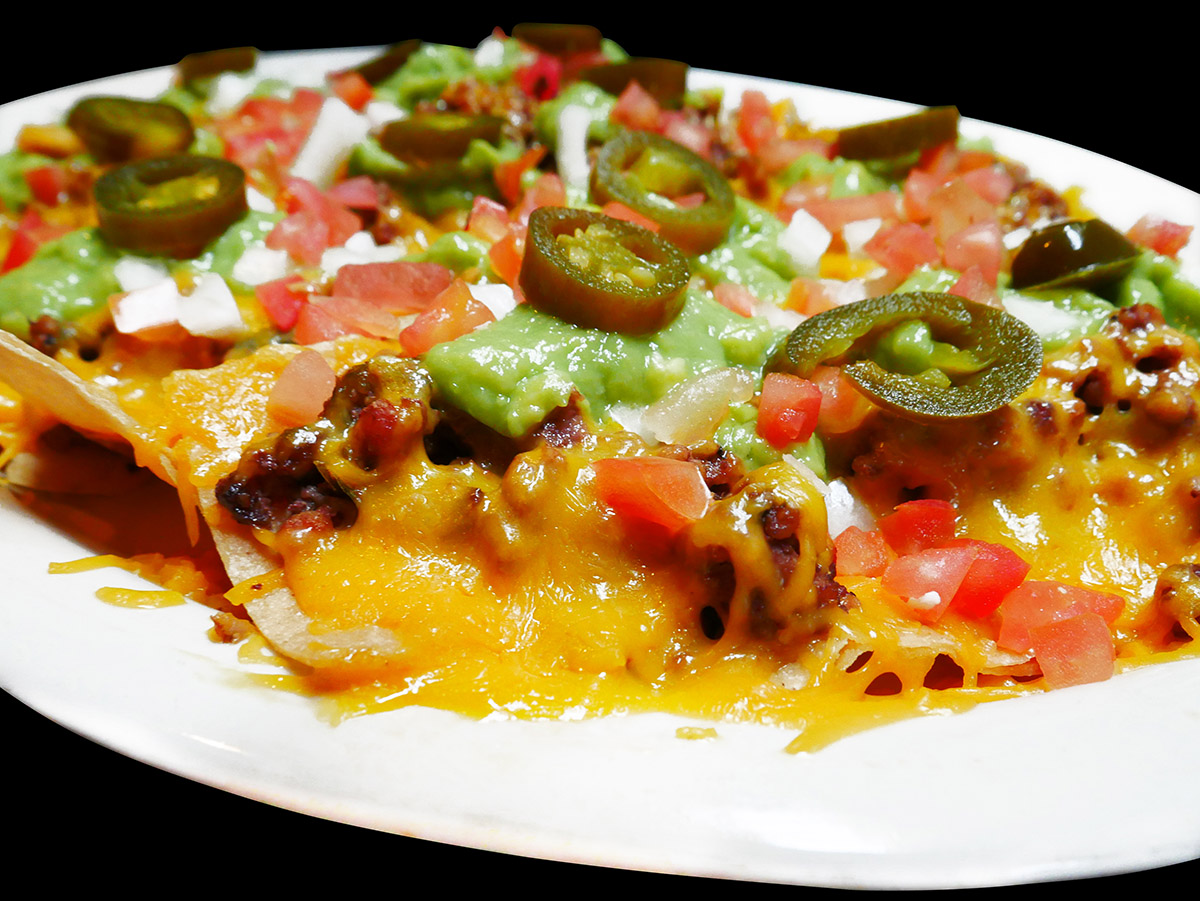 Nachos with beef, jalapenos, avacado, tomato and of course cheese